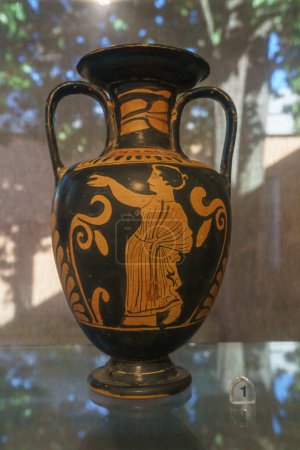 Ancient clay pot called Amphora, painted with black figures on a red background