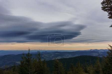 Evening view at Grand Brezouard over the Rhine Valley at mountain landscape of Vosges up to the distant Alps during winter, Alsace, France