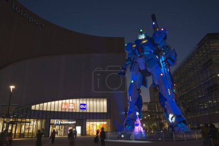 Photo for Fukuoka, Japan - December 6 2022: Full-size Mobile suit RX-93ffv Gundam at the Gundam Park in front of Mitsui Shopping Park Lalaport Fukuoka of the night - Royalty Free Image