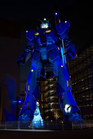 Photo for Fukuoka, Japan - December 6 2022: vertical image of Mobile suit RX-93ffv Gundam at the Gundam Park in front of Mitsui Shopping Park Lalaport Fukuoka of the night - Royalty Free Image
