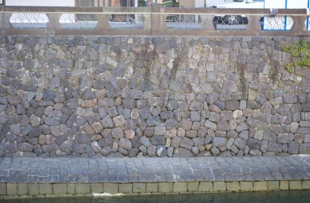 A distant view of a heart-shaped stone on the stone wall at Meganebashi Bridge in Nagasaki. Japan