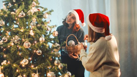 Photo for Happy girls prepare Christmas tree at home - Royalty Free Image