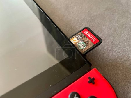 Photo for Prague, Czech Republic - May 11 2023: The Legend of Zelda: Tears of the Kingdom cartridge with game in Nintendo Switch gaming console. This is a sequel to the game Breath of the Wild - Royalty Free Image
