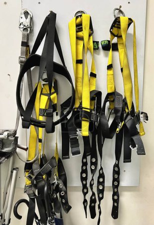 Photo for Industrial safety harness equipment on a wall in a workshop - Royalty Free Image