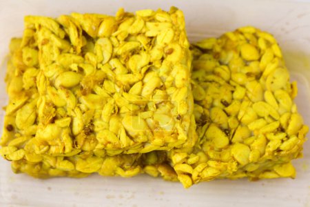 Photo for Raw tempeh marinated in turmeric yellow seasoning - Royalty Free Image