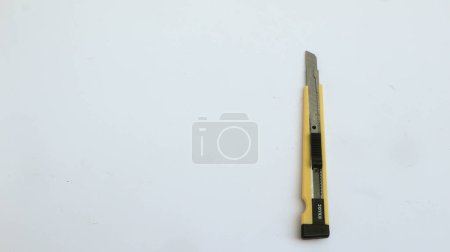 Photo for The yellow stationery knife isolated on white background - Royalty Free Image