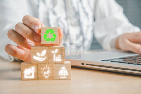 Photo for ESG concept of environmental, Woman hand holding wooden cube block with ESG icon with copy space, social and corporate governance concept - Royalty Free Image