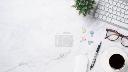 Photo for White office desk with keyboard, eyeglass, pen, mouse and cup of coffee, Top view wth copy space, Flat lay. - Royalty Free Image