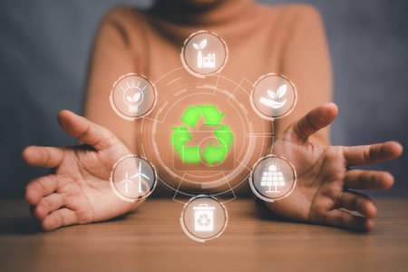 ESG concept of environmental, Green ethical business preserving resources, reducing CO2, caring for employees. Woman hand holding with VR screen ESG icon.