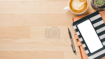 Foto de Office desk workspace with blank screen smart phone, notebook, pen and cup of coffee, Top view flat lay with copy space. - Imagen libre de derechos