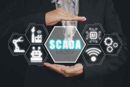 Foto de SCADA Supervisory control and data acquisition technology concept, Person hand holding SCADA icon on virtual screen. - Imagen libre de derechos