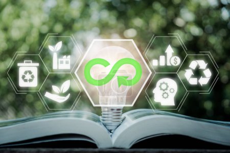 Circular economy concept, Light bulb on book with circular economy icon on virtual screen, renovating and recycling existing materials and products as much possible.