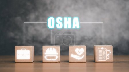 Téléchargez les photos : Concept d'industrie de l'Administration de la sécurité et de la santé au travail (OSHA), bloc en bois avec l'icône OSHA sur l'écran virtuel. - en image libre de droit