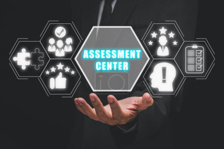 Photo for Assessment center concept, Businessman hand holding assessment center icon on virtual screen. - Royalty Free Image