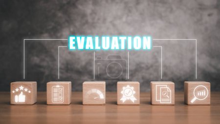 Photo for Evaluation concept, Wooden block on desk with evaluation icon on virtual screen. - Royalty Free Image