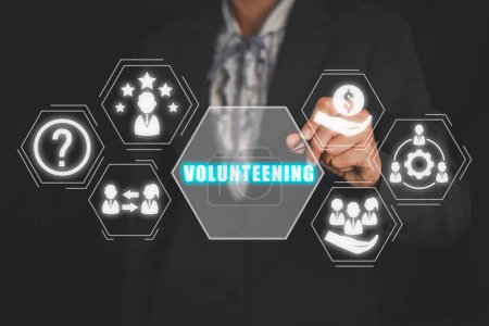 Photo for Volunteening concept, Businesswoman hand touching volunteening icon on virtual screen. - Royalty Free Image