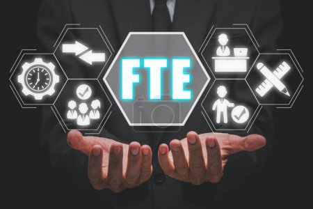 Photo for FTE, Full time equivalent concept, Businessman hand holding full time equivalent icon on virtual screen, equivalent, employee, workload, measure and comparability. - Royalty Free Image