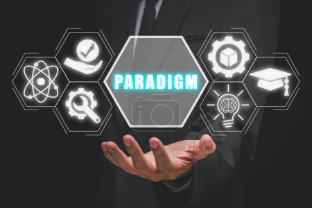 Foto de Concepto de paradigma, Empresario de mano sosteniendo el icono del paradigma en la pantalla virtual. Filosofía, Ciencia, Teoría, Patrón de Pensamiento, Retórica, Postulado. - Imagen libre de derechos