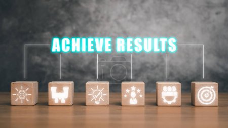 Photo for Achieve results concept, Wooden block on desk with achieve results icon on virtual screen. - Royalty Free Image