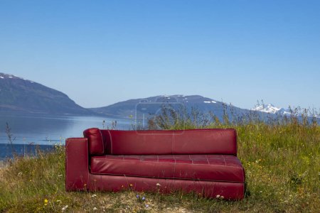 Red sofa on the background of mountains, Norvay