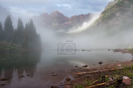 Photo for View of Maroon Bells after a morning rain storm. The Maroon Bells are located near the town of Aspen Colorado. An avalanche the season before left debris of fallen trees in Maroon Lake. - Royalty Free Image