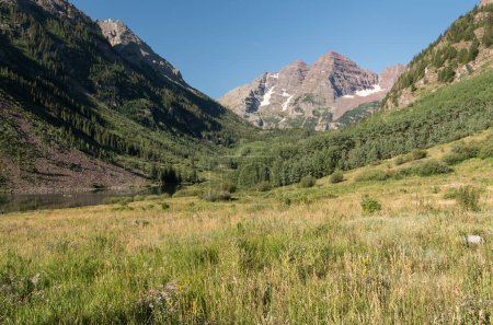 A beautiful August Summer day in the valley of the Maroon Bells in Central Colorado. The Maroon Bells Wilderness surrounds the area which is visited by tourists from around the world.