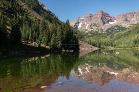 Photo for Maroon Bells Reflection on Maroon Lake near Aspen Colorado. A still morning reflection of the Maroon Bells that are located in the Maroon Bells Snowmass Wilderness Area of Central Colorado. - Royalty Free Image
