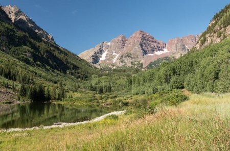 A beautiful August Summer day in the valley of the Maroon Bells in Central Colorado. The Maroon Bells Snowmass Wilderness surrounds the area which is visited by tourists from around the world.