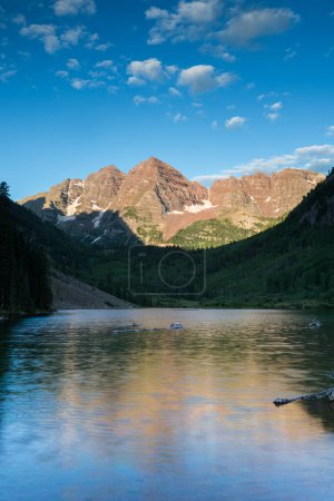 Photo for A popular destination for scenic views. the Maroon Bells are appreciated by many people from around the world. This early morning view has a diffused reflection from the moving water on Maroon Lake. - Royalty Free Image