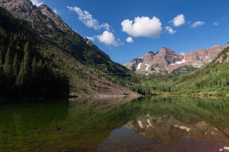 Photo for High Peaks Rise Above Maroon Lake with the Famous Maroon Bells as a Backdrop. The Maroon Bells Snowmass Wilderness Area surrounds the valley which is visited by tourists from around the world. - Royalty Free Image