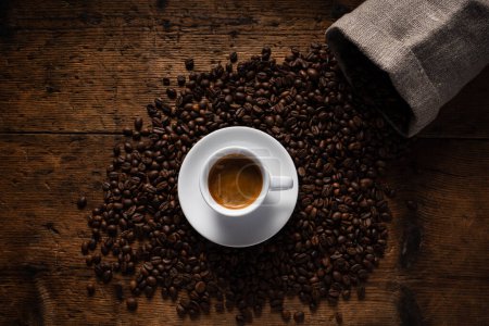 Photo for Top view cup of coffee on top of coffee beans. - Royalty Free Image