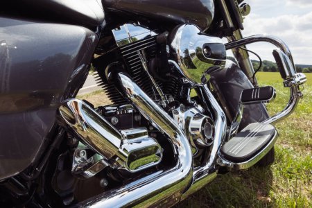 Téléchargez les photos : Black motorcycle side view close-up ,motorbike stands on green grass isolated. High quality photo - en image libre de droit