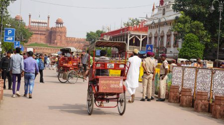 Photo for Red Fort laborer driving rickshaw on chandni chowk road - Royalty Free Image