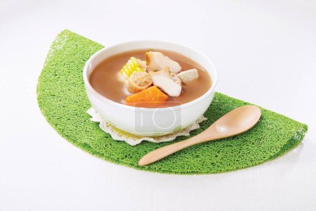 Photo for Pork tendon soup with scallops, snails, lily and sweet potato served in a bowl isolated on napkin side view of hong kong food - Royalty Free Image