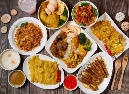 Photo for Curry Chicken Rice, Fried tempeh, chow mein, Noodles, Fried Turtledove, Padang Beef, vegetable cake, duck tongue, juice soda with chilli sauce served in dish isolated on table side view of taiwan food - Royalty Free Image