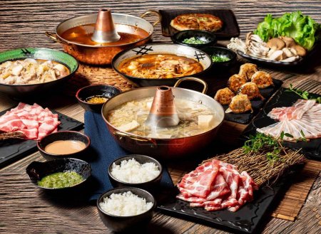 Assortment of Spicy Pot Bottom Set, White Meat, Sauerkraut Fried Dumplings, Pork Belly, Pork Plum Blossom, US prime beef ribs with chopsticks served in pot isolated on table top view of taiwan food