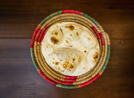 Photo for Tandoori khamiri roti served in basket isolated on table top view of india and pakistani food - Royalty Free Image