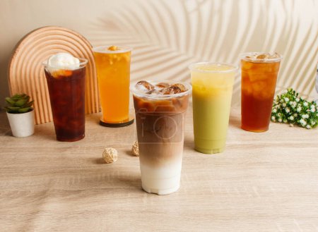 Photo for Assorted iced tea Coffee Milk, Green Tea Polyphenols, Ice Cream Black Tea, Ancient Winter Melon, Pineapple served in disposable glass top view of taiwan drink - Royalty Free Image
