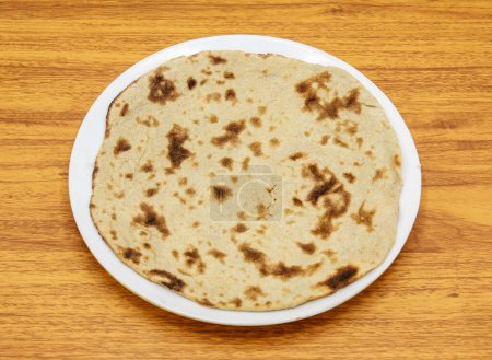 Photo for Simple tandoori roti served in plate isolated on table top view of indian and pakistani spicy food - Royalty Free Image