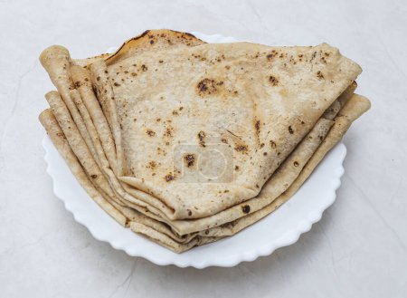 Foto de Tawa chapati roti served in plate isolated on table top view of indian and pakistani spicy food - Imagen libre de derechos