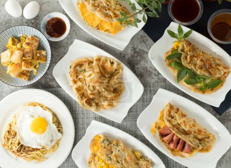 Assorted taiwan pancake food Corn and Egg Scallion pancake Grabs, Basil, cheese, onion, Bacon, black pepper Mushroom Sizzling Noodles, Carrot Cake with Eggs, winter melon tea, black tea served