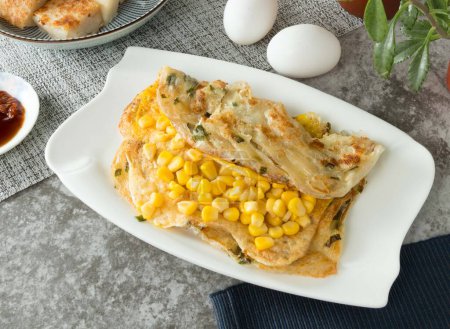 Corn and Egg Scallion pancake Grabs wrap served in dish isolated on napkin top view on table taiwan food