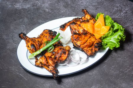 Téléchargez les photos : Tandoori Chicken with onion and salad served in dish isolated on grey background top view of indian and bangladesh food - en image libre de droit