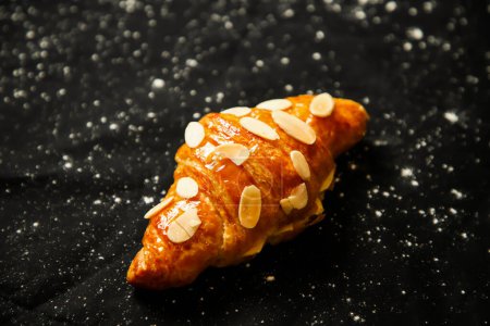 Photo for Almond Croissant topping with nuts isolated on dark background top view of french breakfast baked food item - Royalty Free Image