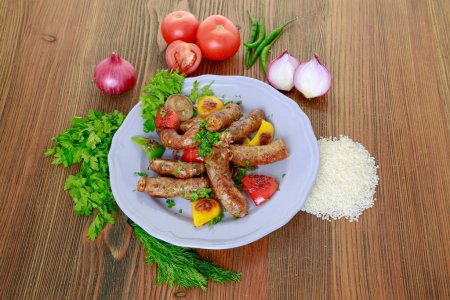 Photo for Grilled mumbar or sausage grill with onion, tomato and coriander served in dish isolated on table top view of arabic food - Royalty Free Image