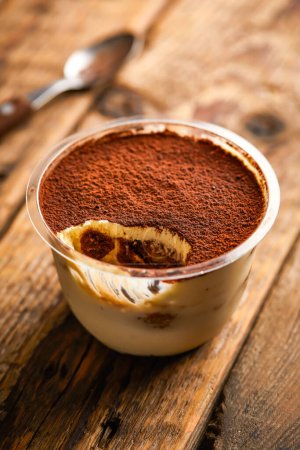 Photo for Jacopo Tiramisu Mousse served in jar isolated on wooden table top view of arabic sweet dessert - Royalty Free Image