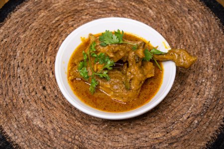 Chicken Rezala korma karahi served in dish isolated on wooden background top view indian spices, bangladeshi and pakistani food
