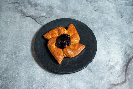 Blueberry Danish puff pastry filled with sweet cheese served in plate isolated on background top view of baked food indian dessert