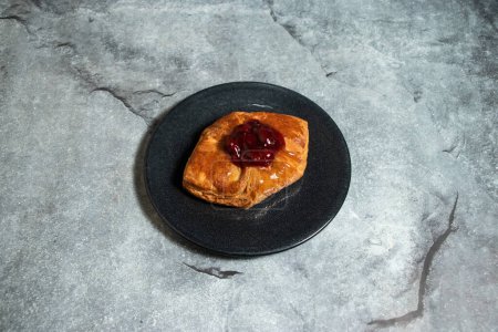 Strawberry Danish puff pastry filled with sweet cheese served in plate isolated on background top view of baked food indian dessert