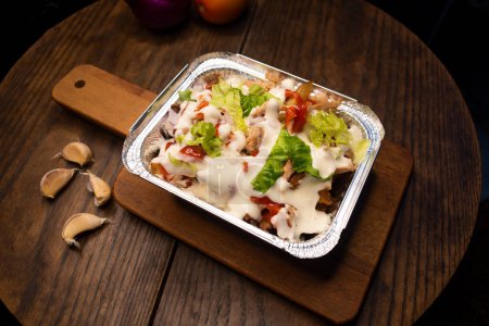 Pizza Loaded Fries topping with mayo and chilli sauce served in dish isolated on wooden board top view of italian fastfood spices snack